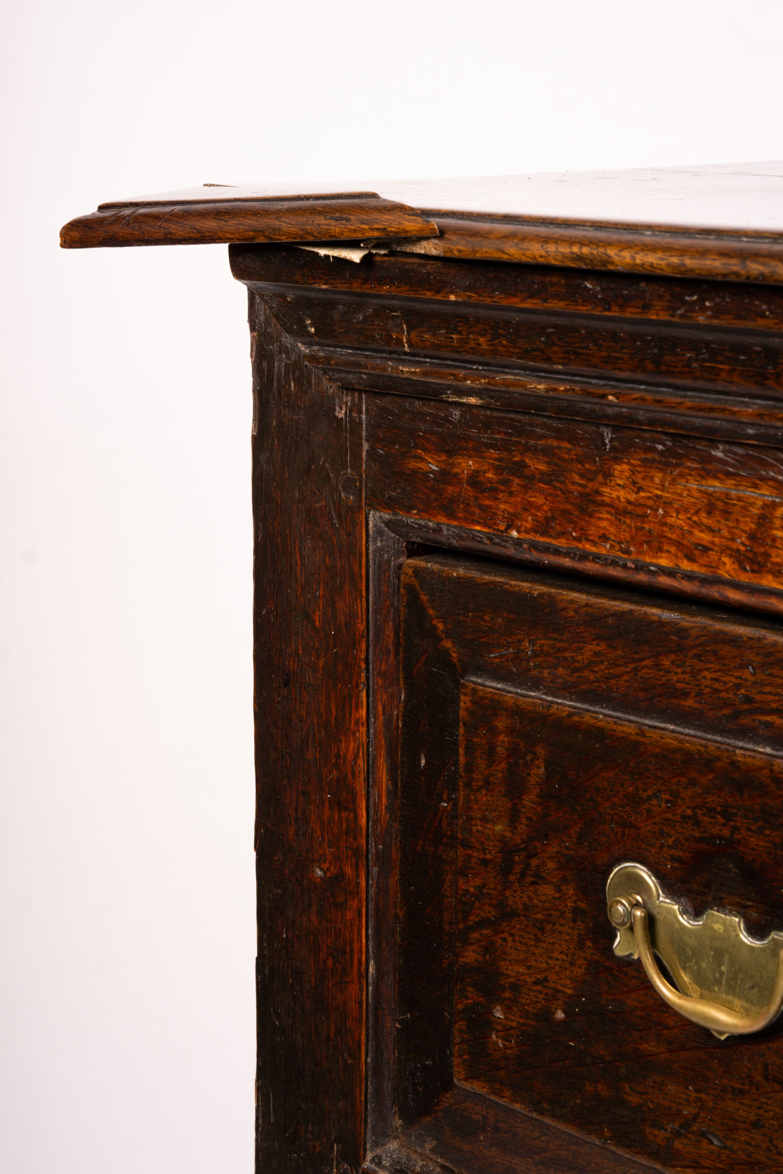 An 18th century oak low dresser on pole turned legs and pad feet, length 198cm, depth 53cm, height 88cm